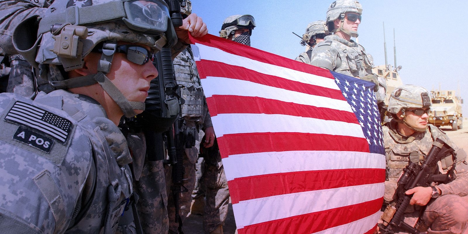 Soldiers holding American flag